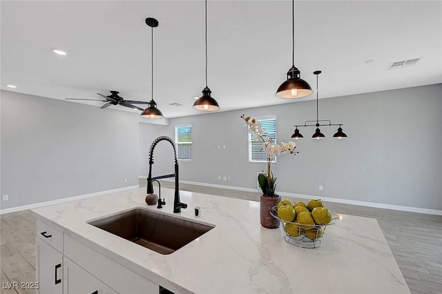 8349 Pollenzo Ave, Las Vegas, NV 89178 - kitchen with a sink, open floor plan, pendant lighting, light stone counters, and a ceiling fan