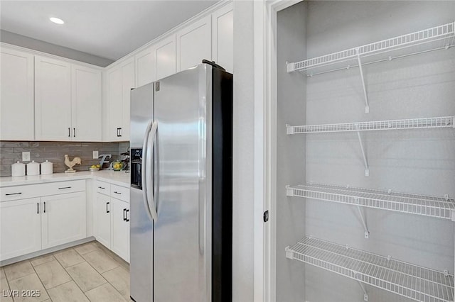 8349 Pollenzo Ave, Las Vegas, NV 89178 - kitchen featuring stainless steel refrigerator with ice dispenser, white cabinets, backsplash, light countertops, and recessed lighting