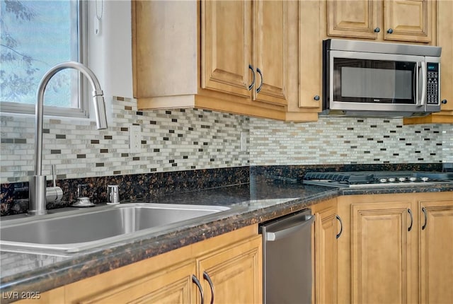 437 Via Stretto Ave, Henderson, NV 89011 - kitchen featuring a sink, tasteful backsplash, appliances with stainless steel finishes, and dark stone countertops