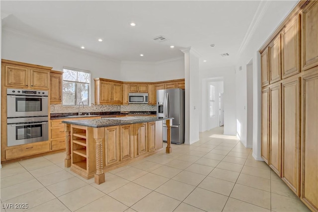 437 Via Stretto Ave, Henderson, NV 89011 - kitchen featuring tasteful backsplash, a center island, a sink, appliances with stainless steel finishes, and crown molding
