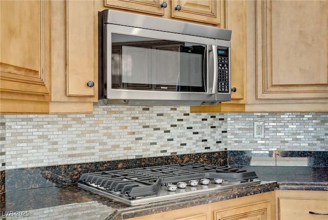 437 Via Stretto Ave, Henderson, NV 89011 - kitchen featuring dark countertops, backsplash, and appliances with stainless steel finishes