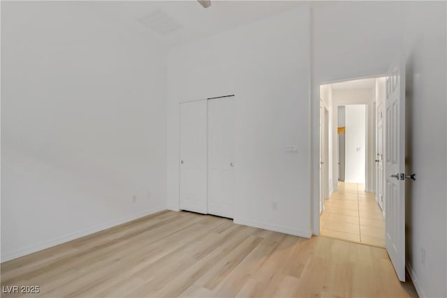 437 Via Stretto Ave, Henderson, NV 89011 - unfurnished bedroom with baseboards, light wood-style floors, visible vents, and a closet