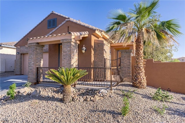 437 Via Stretto Ave, Henderson, NV 89011 - view of front of property with a garage, fence, concrete driveway, stucco siding, and a gate