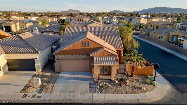 437 Via Stretto Ave, Henderson, NV 89011 - view of front of house featuring concrete driveway, a residential view, an attached garage, and a tile roof
