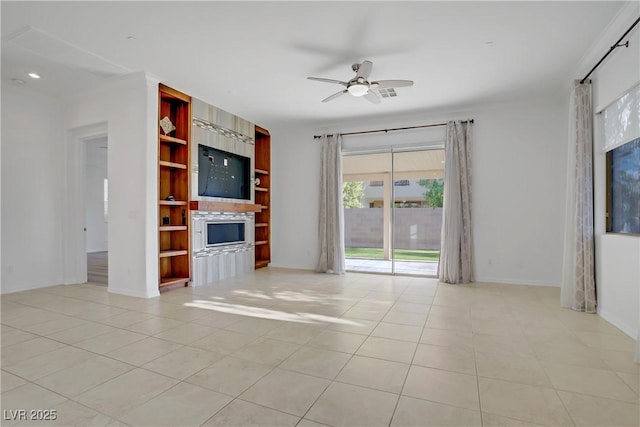 437 Via Stretto Ave, Henderson, NV 89011 - unfurnished living room featuring a ceiling fan, light tile patterned flooring, baseboards, a fireplace, and built in features