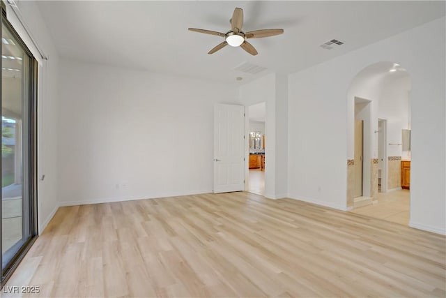 437 Via Stretto Ave, Henderson, NV 89011 - empty room with arched walkways, visible vents, ceiling fan, and light wood-style flooring