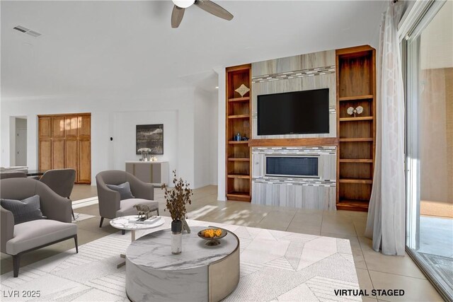 437 Via Stretto Ave, Henderson, NV 89011 - living area with visible vents, a ceiling fan, built in shelves, and light tile patterned floors