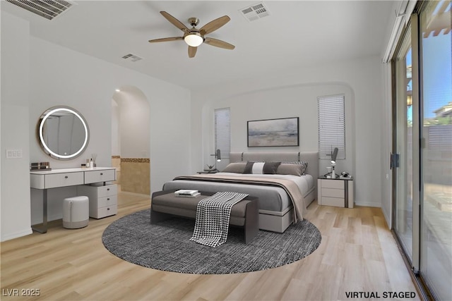 437 Via Stretto Ave, Henderson, NV 89011 - bedroom with arched walkways, visible vents, and light wood-style flooring