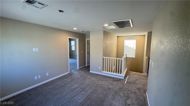 empty room with carpet flooring, recessed lighting, and baseboards