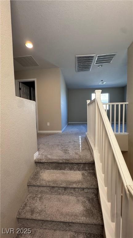 stairs featuring carpet flooring, baseboards, and recessed lighting