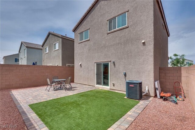 5256 Sherwood Forest Ln, Las Vegas, NV 89122 - rear view of house featuring central AC unit, a patio area, a yard, a fenced backyard, and stucco siding