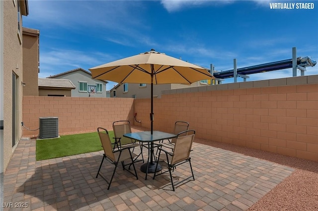 5256 Sherwood Forest Ln, Las Vegas, NV 89122 - view of patio with central air condition unit, outdoor dining space, and a fenced backyard