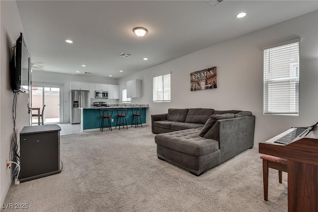 5256 Sherwood Forest Ln, Las Vegas, NV 89122 - living room featuring recessed lighting, plenty of natural light, and light carpet
