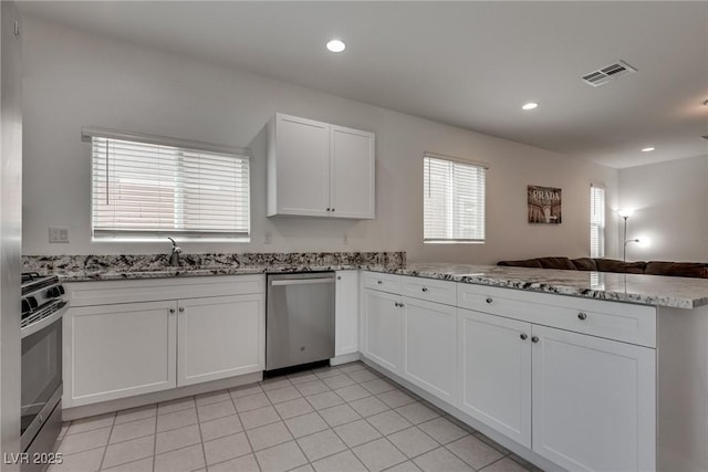 5256 Sherwood Forest Ln, Las Vegas, NV 89122 - kitchen featuring a peninsula, visible vents, a sink, stainless steel appliances, and plenty of natural light