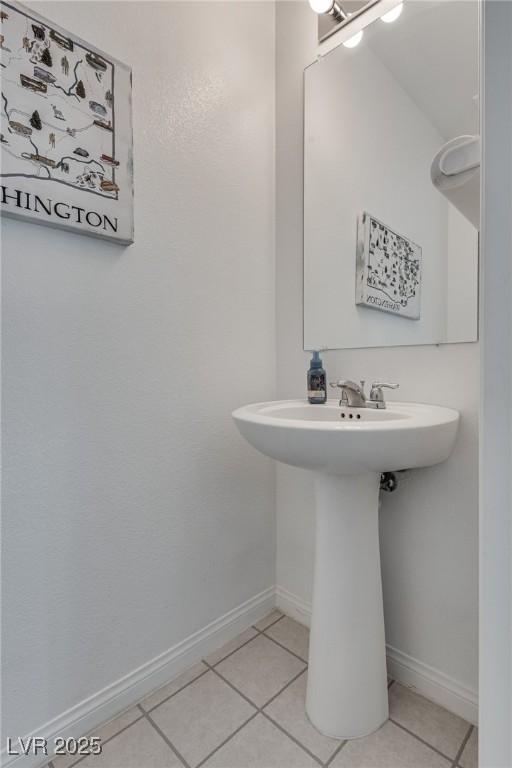 5256 Sherwood Forest Ln, Las Vegas, NV 89122 - bathroom with tile patterned floors, baseboards, and a sink