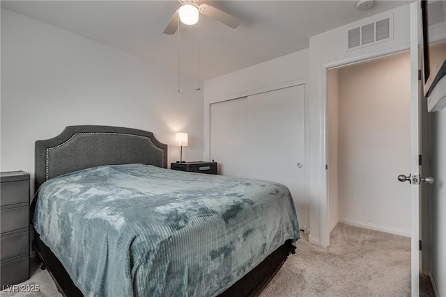 5256 Sherwood Forest Ln, Las Vegas, NV 89122 - bedroom with a closet, a ceiling fan, visible vents, light carpet, and baseboards