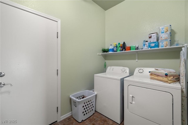 clothes washing area with laundry area, baseboards, tile patterned flooring, and washing machine and dryer