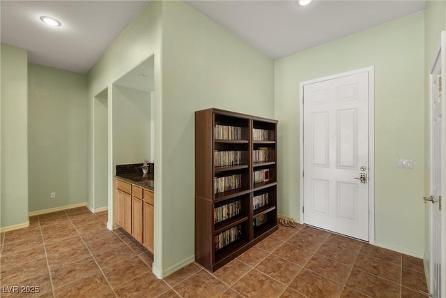 hallway featuring baseboards, recessed lighting, and tile patterned flooring