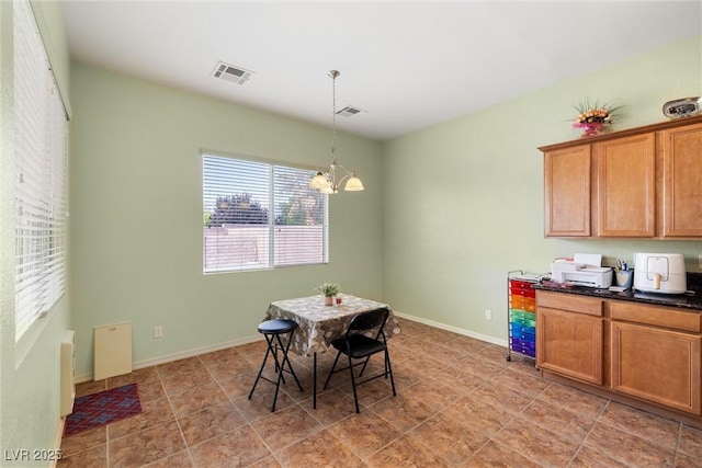 dining area featuring a notable chandelier, baseboards, and visible vents