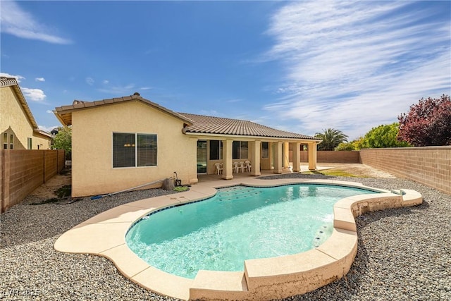 view of swimming pool with a fenced backyard, a fenced in pool, and a patio area