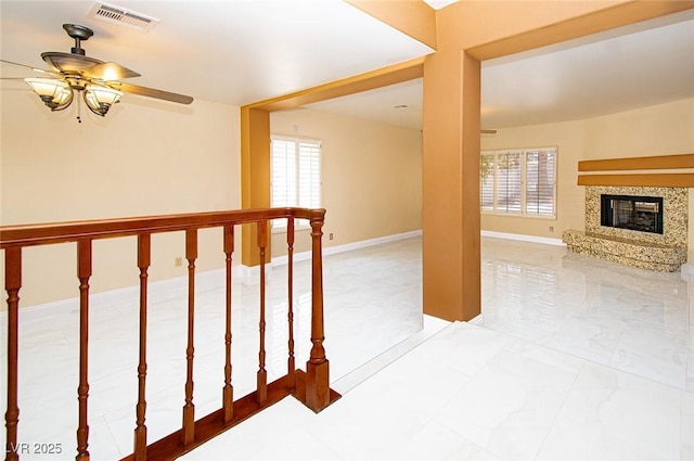 hallway with visible vents and baseboards