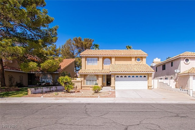 view of front facade with concrete driveway, stucco siding, a tile roof, a garage, and fence