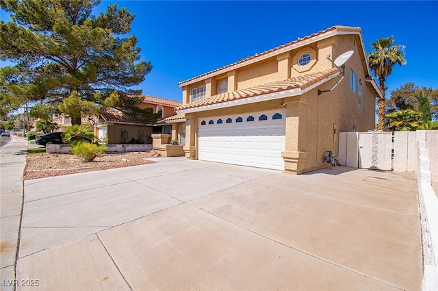 view of front facade featuring concrete driveway, stucco siding, an attached garage, and a tile roof