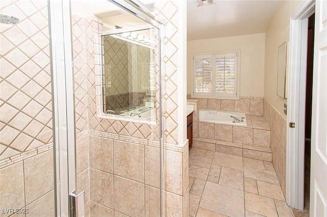 full bathroom featuring a stall shower, a garden tub, and visible vents