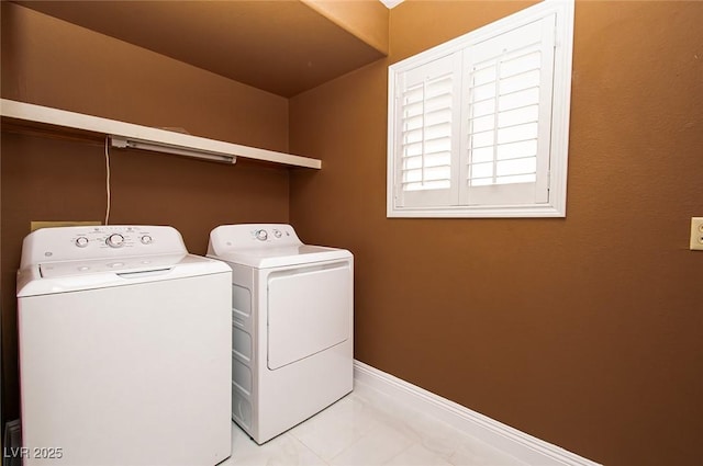 laundry room with washing machine and dryer, laundry area, and baseboards