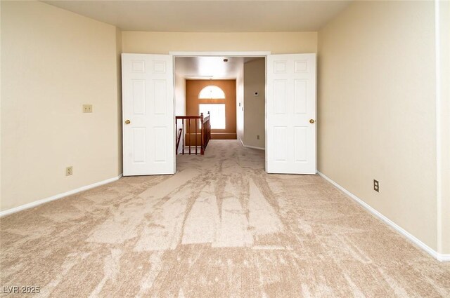 carpeted spare room with baseboards