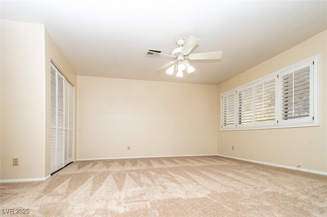 unfurnished bedroom featuring light carpet and baseboards
