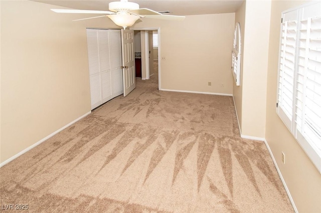 unfurnished bedroom featuring a closet, baseboards, and carpet