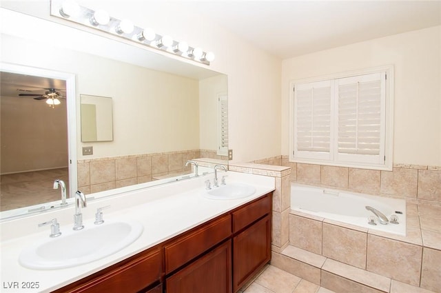 full bathroom featuring a sink, a bath, a ceiling fan, and double vanity