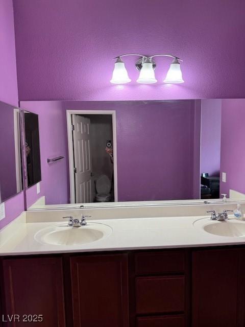 full bath featuring double vanity and a sink
