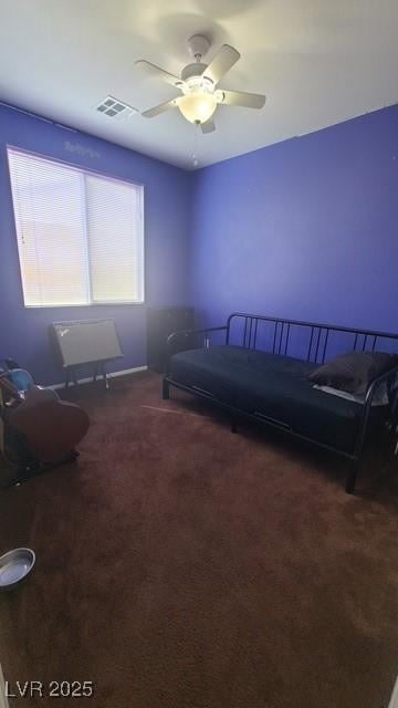 carpeted bedroom featuring visible vents and a ceiling fan