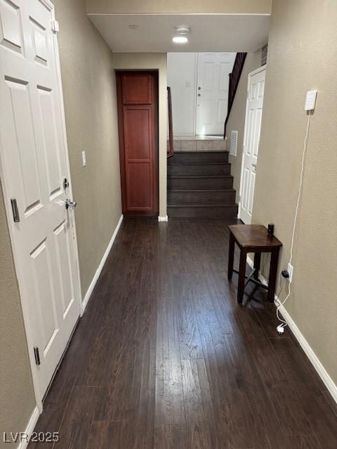 hall with baseboards, stairway, and dark wood-style floors