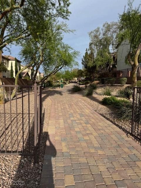 view of home's community featuring fence