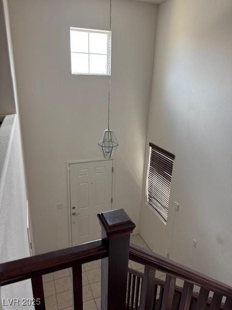 interior space with tile patterned flooring and a towering ceiling