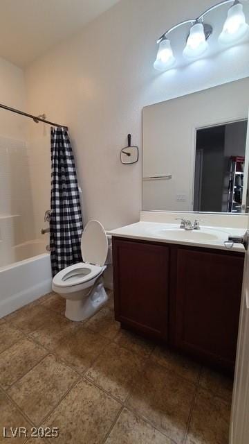 full bath featuring tile patterned flooring, shower / bath combo with shower curtain, vanity, and toilet