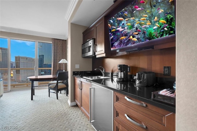 135 E Harmon Ave Unit 2515, Las Vegas, NV 89109 - kitchen featuring a sink, stainless steel microwave, refrigerator, crown molding, and dark countertops