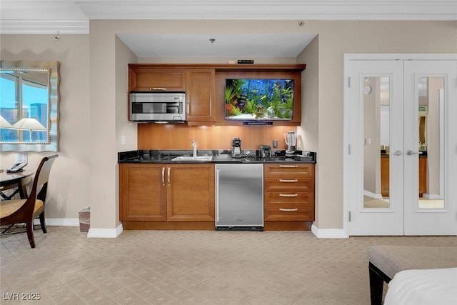 135 E Harmon Ave Unit 2515, Las Vegas, NV 89109 - bar with appliances with stainless steel finishes, french doors, baseboards, crown molding, and a sink