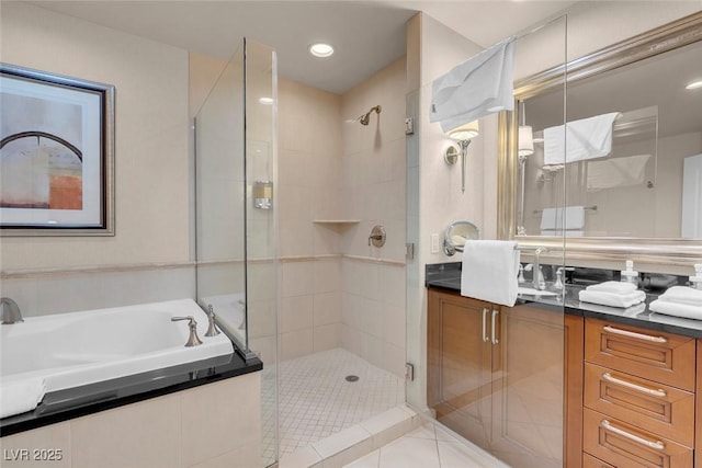 135 E Harmon Ave Unit 2515, Las Vegas, NV 89109 - bathroom with a stall shower, vanity, a bath, tile patterned floors, and recessed lighting