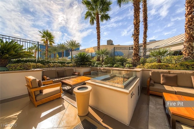 135 E Harmon Ave Unit 2515, Las Vegas, NV 89109 - view of patio / terrace with an outdoor living space with a fire pit and fence