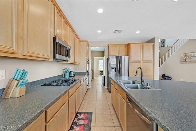 8828 Monte Oro Dr, Las Vegas, NV 89131 - kitchen with appliances with stainless steel finishes, dark countertops, light brown cabinetry, light tile patterned floors, and recessed lighting