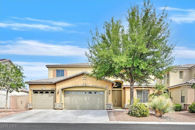 8828 Monte Oro Dr, Las Vegas, NV 89131 - view of front facade with a garage, stucco siding, driveway, and stone siding