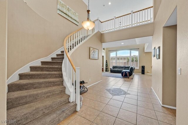 8828 Monte Oro Dr, Las Vegas, NV 89131 - stairway with tile patterned flooring and a towering ceiling