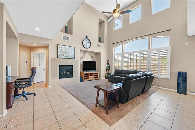 8828 Monte Oro Dr, Las Vegas, NV 89131 - tiled living area with a ceiling fan, a towering ceiling, a tile fireplace, and recessed lighting