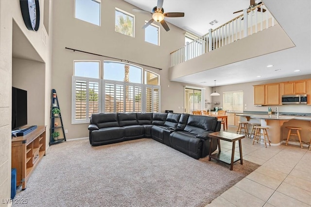 8828 Monte Oro Dr, Las Vegas, NV 89131 - living area featuring ceiling fan, a high ceiling, healthy amount of natural light, light tile patterned flooring, and recessed lighting