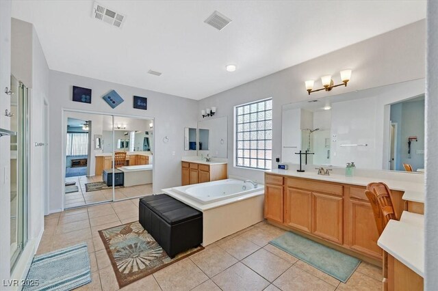 8828 Monte Oro Dr, Las Vegas, NV 89131 - full bath with two vanities, a whirlpool tub, a stall shower, and tile patterned flooring