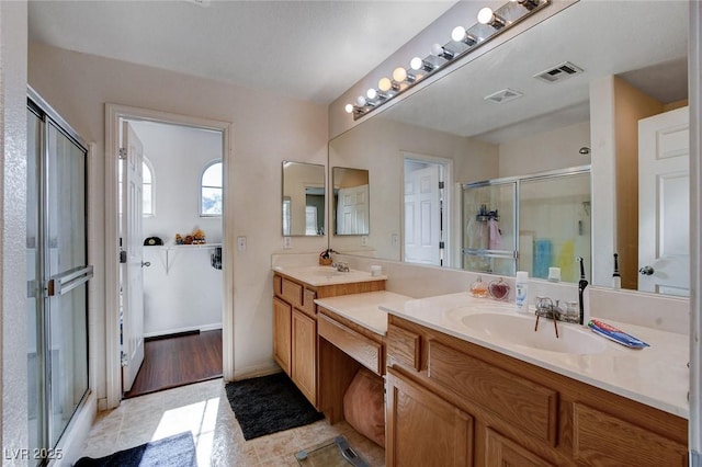 4777 Mereworth Ct, Las Vegas, NV 89130 - full bath featuring a shower stall, double vanity, a sink, and visible vents